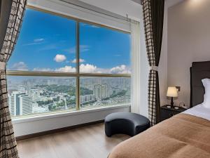 a bedroom with a large window with a city view at Annie Apartment 3204 River View -only 120 meters from Metro Line 2 Exit of Chuanxinggulou in Kunming