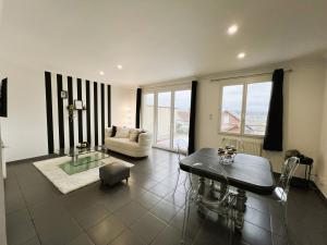a living room with a couch and a table at Maison Panorama avec terrasse exposition sud in Mers-les-Bains