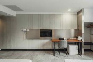 a room with a desk with a television and a chair at Hwa Nan Hotel in Yongkang