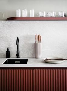 a kitchen counter with a sink and a plate at HeyMi Apartments Brick Lane Vienna in Vienna