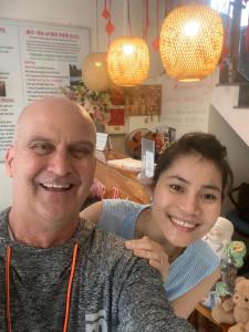 a man and a woman posing for a picture at Bonjour Hostel in Hue