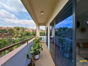 a balcony with plants and a view of the city at Chic studio with amazing view in Yaoundé