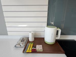 a coffee maker on a wooden tray on a counter at Sky Star in Incheon +14 photos