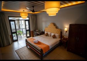 a bedroom with a large bed and a balcony at The Project Cafe and Hotel in Aldona