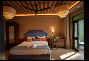 a bedroom with a bed with a stuffed animal laying on it at The Project Cafe and Hotel in Aldona