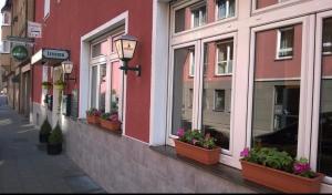 a street with potted plants on the side of a building at Swan Rooms in Nuremberg