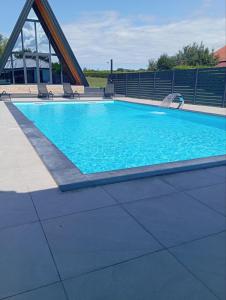a swimming pool with blue water in a building at Villa Rustic in Majetići