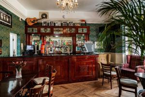 a bar in a restaurant with a table and chairs at Sefton Park Hotel in Liverpool