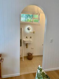 a bathroom with a sink and a window at Moana bungalow in Hideaway Bay