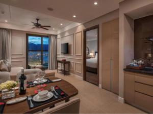 a living room with a kitchen and a room with a bed at DN ALT sentafe ppt in Danang