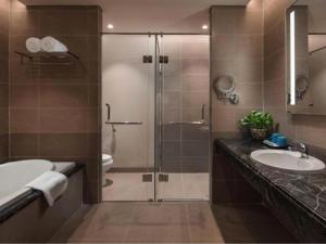 a bathroom with a shower and a sink and a toilet at DN ALT sentafe ppt in Danang