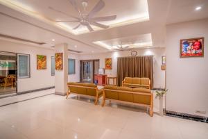 a waiting room with chairs and a ceiling fan at HOTEL KB's Grand in Shirdi