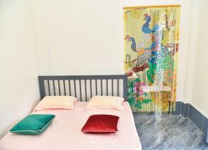 a bed with two pillows on it in a room at Mekongdelta in Can Tho