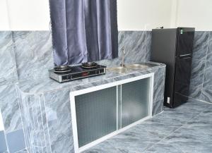 a kitchen with a counter with a sink and a microwave at Mekongdelta in Can Tho