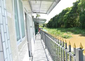 a porch of a house with a fence at Mekongdelta in Can Tho