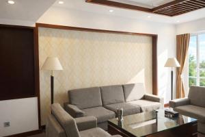 a living room with a couch and a table at Central Hotel in Móng Cái