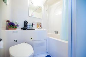 a white bathroom with a toilet and a shower at Happy Osaka City in Osaka +44 photos