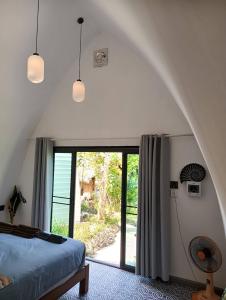 a bedroom with a bed and a large window at Castaway on Mook in Ko Mook