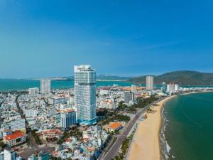 an aerial view of a city with a beach and buildings at Oceanus Sea View Quy Nhon Apartment in Quy Nhon