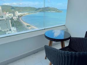a table and chairs on a balcony with a view of the ocean at Oceanus Sea View Quy Nhon Apartment in Quy Nhon +2 photos