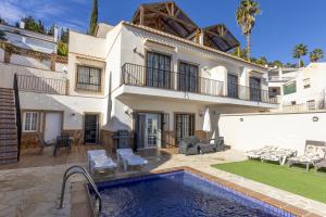 a house with a swimming pool in front of it at House Miramar almuñecar in Almuñécar