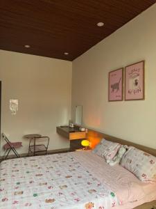 a bedroom with a large bed and a table at Nhà Bơ Homestay 2 in Danang +27 photos