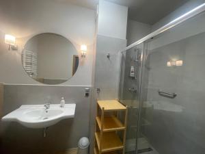 a bathroom with a sink and a shower at Apartamenty Panoramic-Piecki in Piecki