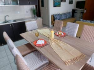 a wooden table with two wine glasses on it at Hellen's Summer house in Keramoti
