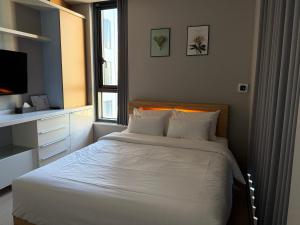 a bedroom with a white bed with a window at Sky Star in Incheon