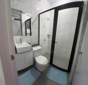 a bathroom with a toilet and a sink and a shower at 2 bedroom Flat in Namaka,Nadi in Nadi +8 photos