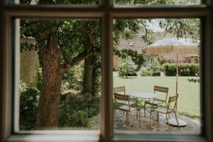 a view of a table and chairs from a window at Domaine La Commanderie in Boersch
