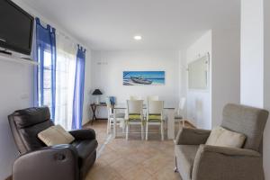 a living room with a couch and chairs and a table at House Miramar almuñecar in Almuñécar