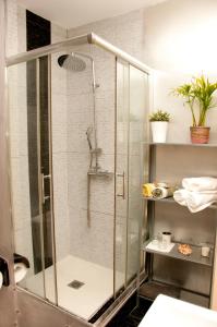 y baño con ducha y puerta de cristal. en P&P Apartament Lagunillas I y II, en Málaga