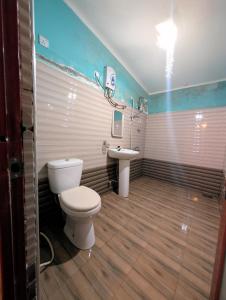 a bathroom with a toilet and a sink at Prasada Resort in Badulla