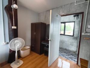 a room with a fan and a bathroom with a window at Poohry Seaview in Ko Lanta +196 photos