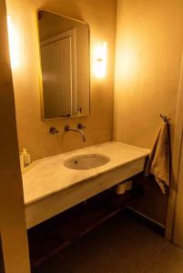 a bathroom with a sink and a mirror at Vevi Villas in Vévi +25 photos