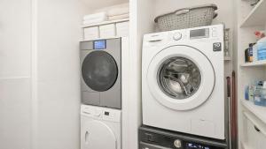 a washing machine and a washer in a bathroom at Cosy loft near City Centre, Terra CasaMia in Antwerp +9 photos