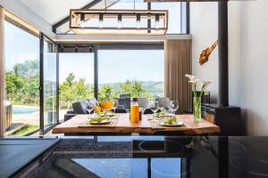 a dining room with a table and a large window at Casas De Bouro 2 Casa Dos Jarros in Terras de Bouro