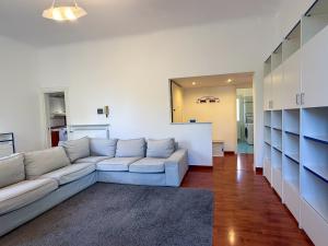 a living room with a couch and a kitchen at Casa Lungomare in Arenzano