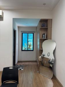 a living room with a chair and a window at Nhà Bơ Homestay 2 in Danang