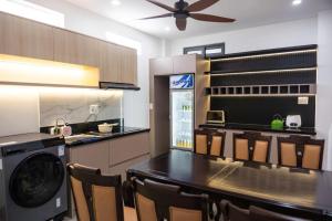 a kitchen with a table and a washer and dryer at BY Home in Hue