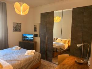 a bedroom with two beds and a mirror at GuestHouse Modena Buon Pastore in Modena