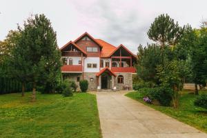 a large house with an orange roof at Casa Natalia in Sinaia