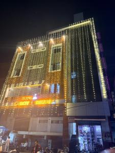a large building with lights on it at night at Hotel Shri Goverdhan in Bahraich