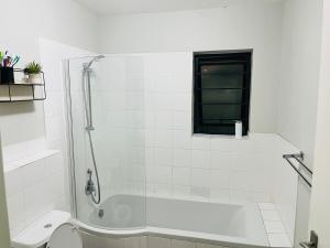 a white bathroom with a shower and a toilet at Valley Escape in Cape Town +11 photos