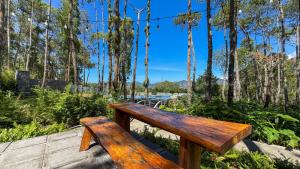 a wooden bench sitting on top of a wooden deck at La Pino Mount Batur and Hot Spring in Bangli