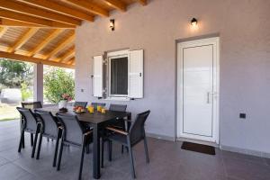 a dining room with a black table and black chairs at Santa Marina House in Lefkada +36 photos