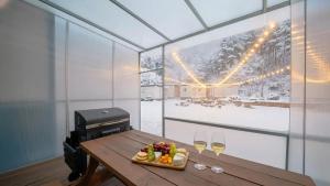 a table with a plate of food and two glasses of wine at GaPyeong Yeoldudal Spapension&Camping in Gapyeong