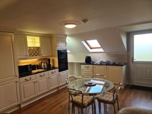 a kitchen with a table and chairs in a room at This is the Place in Ballinrobe