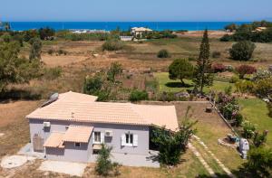 an aerial view of a house with the ocean in the background at Santa Marina House in Lefkada
